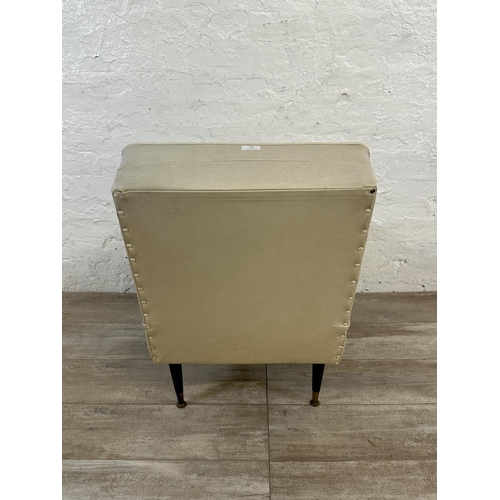 39 - A mid 20th century cream vinyl upholstered lounge chair on dansette legs - approx. 84cm high x 53cm ... 