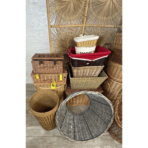 4 - A collection of wicker furniture to include three section folding dressing screen, baskets, bottle r... 