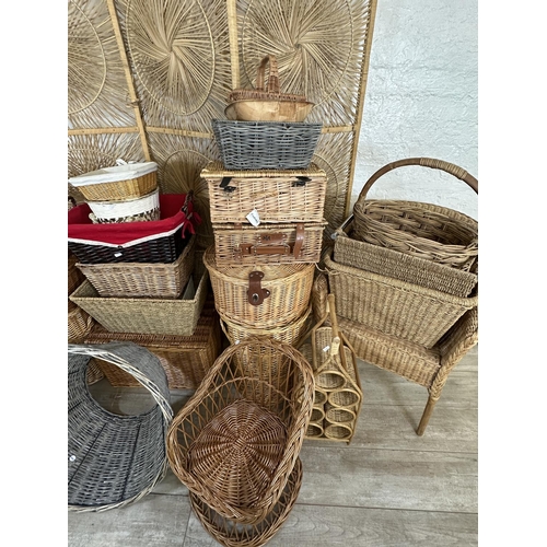 4 - A collection of wicker furniture to include three section folding dressing screen, baskets, bottle r... 