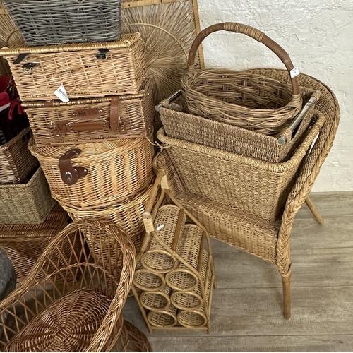 4 - A collection of wicker furniture to include three section folding dressing screen, baskets, bottle r... 