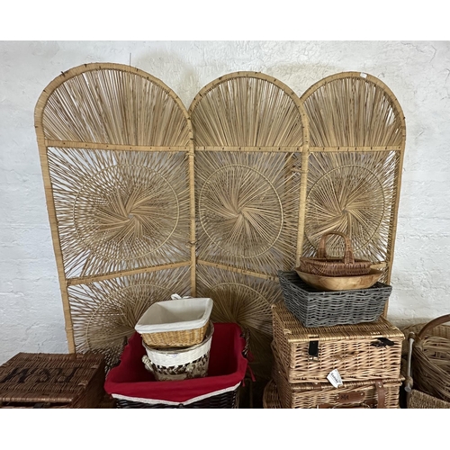 4 - A collection of wicker furniture to include three section folding dressing screen, baskets, bottle r... 