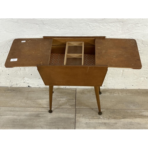 47 - A mid 20th century teak and plywood sewing box on beech splayed supports - approx. 57cm high x 26cm ... 