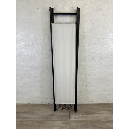 55 - A black tubular metal and white fabric four section folding dressing screen - approx. 173cm high x 1... 