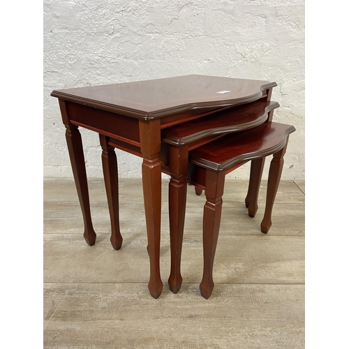 61 - Two pieces of furniture, one mid 20th century teak ceramic tile top side table and one mahogany nest... 