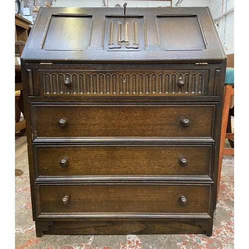 62 - A Priory carved oak bureau - approx. 99cm high x 76cm wide x 45cm deep