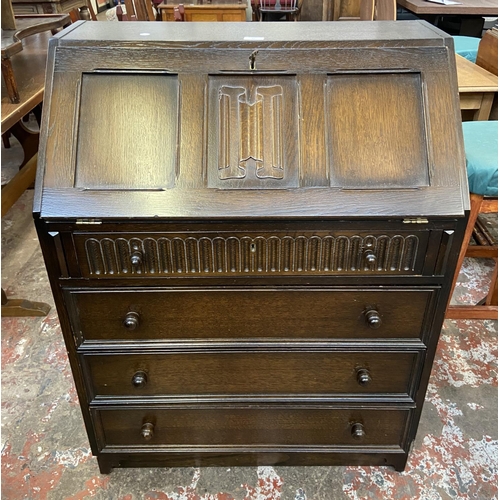 62 - A Priory carved oak bureau - approx. 99cm high x 76cm wide x 45cm deep