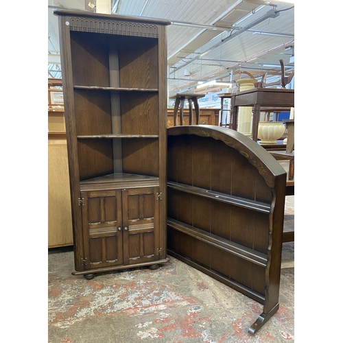 63 - Two pieces of Priory oak furniture, one plate rack and one corner cabinet