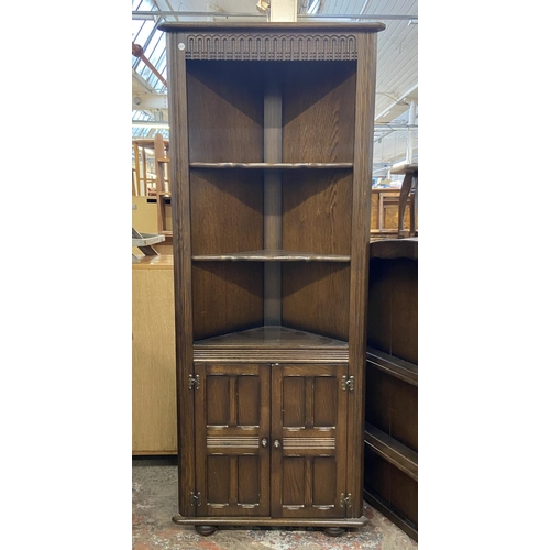 63 - Two pieces of Priory oak furniture, one plate rack and one corner cabinet