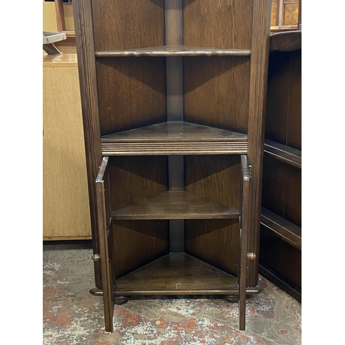 63 - Two pieces of Priory oak furniture, one plate rack and one corner cabinet