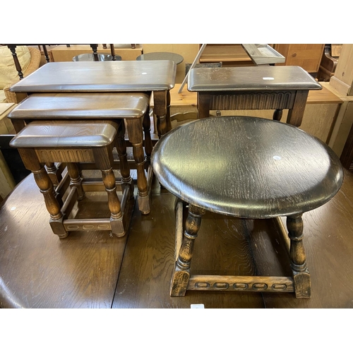 64 - Three pieces of Priory carved oak furniture, one circular side table, one rectangular side table and... 