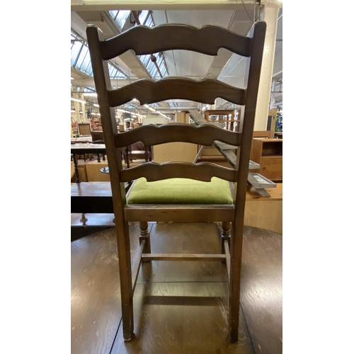 65 - A Priory oak dining table and four green fabric upholstered chairs - approx. 78cm high x 122cm wide ... 