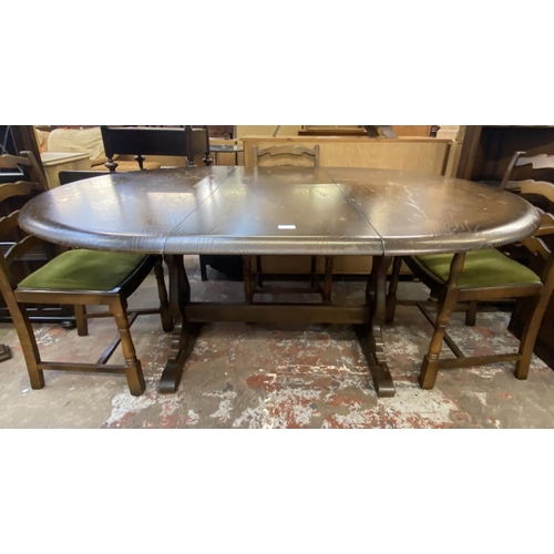 65 - A Priory oak dining table and four green fabric upholstered chairs - approx. 78cm high x 122cm wide ... 