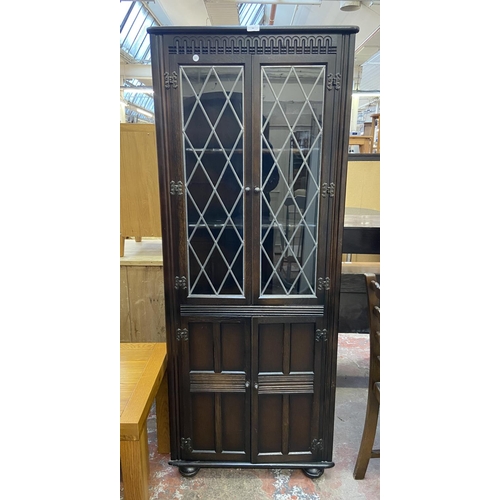 66 - A Priory carved oak and lead glazed free standing corner cabinet - approx. 168cm high x 67cm wide x ... 