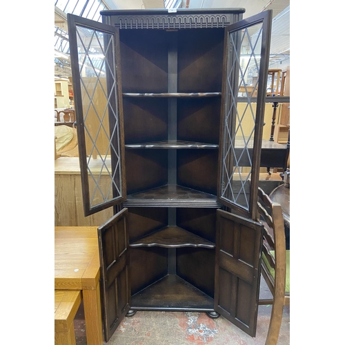 66 - A Priory carved oak and lead glazed free standing corner cabinet - approx. 168cm high x 67cm wide x ... 