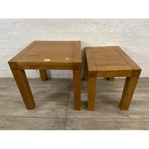 68 - A contemporary solid oak nest of two tables - approx. 50cm high x 50cm wide x 50cm deep