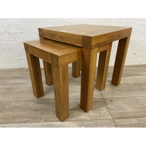 68 - A contemporary solid oak nest of two tables - approx. 50cm high x 50cm wide x 50cm deep