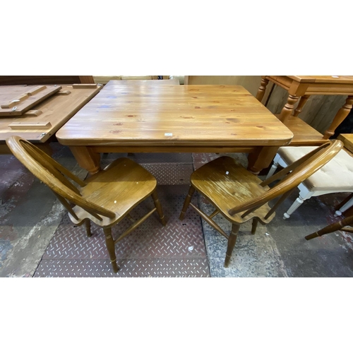 70 - A Victorian style pine farmhouse dining table and four beech wheel back dining chairs - table approx... 