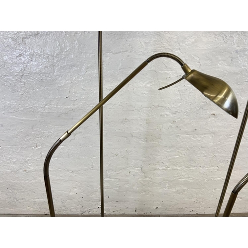 71 - Four contemporary brass effect floor lamps, two B&Q and two Massive