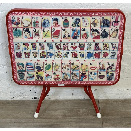 8 - A mid 20th century N.K. red plastic and tubular metal folding Thai alphabet child's table - approx. ... 