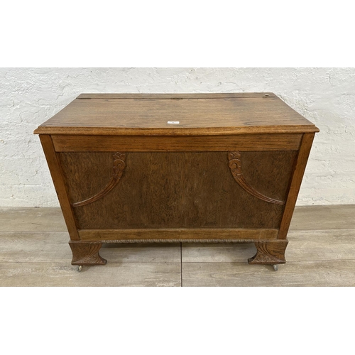 83 - An Art Deco carved oak blanket box - approx. 65cm high x 88cm wide x 43cm deep