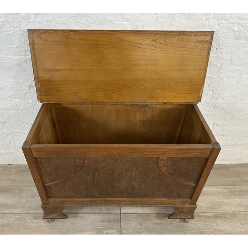 83 - An Art Deco carved oak blanket box - approx. 65cm high x 88cm wide x 43cm deep