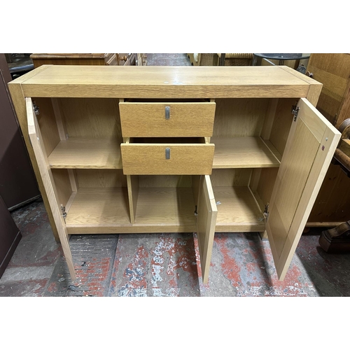 92 - A contemporary oak effect sideboard - approx. 89cm high x 125cm wide x 38cm deep