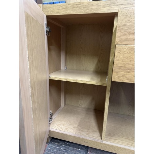 92 - A contemporary oak effect sideboard - approx. 89cm high x 125cm wide x 38cm deep