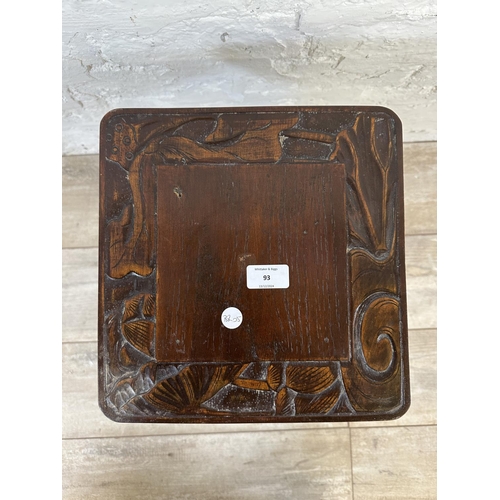 93 - An Arts and Crafts style carved hardwood two tier side table in the manner of Liberty & Co - approx.... 