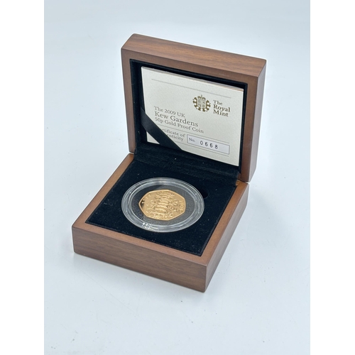 A boxed The Royal Mint The 2009 UK Kew Gardens 50p 22ct gold proof coin with certificate of authenticity - approx. gross weight 15.5g