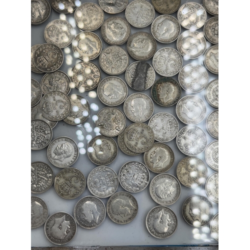 2372 - A framed collection of 92.5% and 50% silver threepences