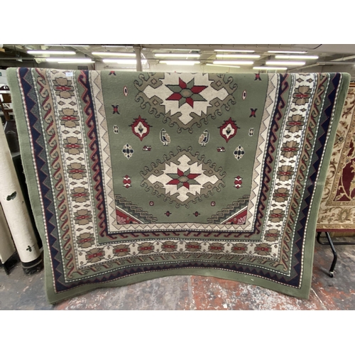 192 - A Belgian Rug Style Traditional Poly Malak green ground rug - approx. 290cm x 200cm