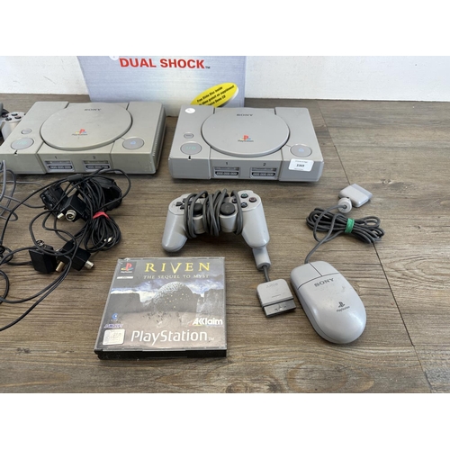 593 - Two Sony PlayStation consoles with accessories