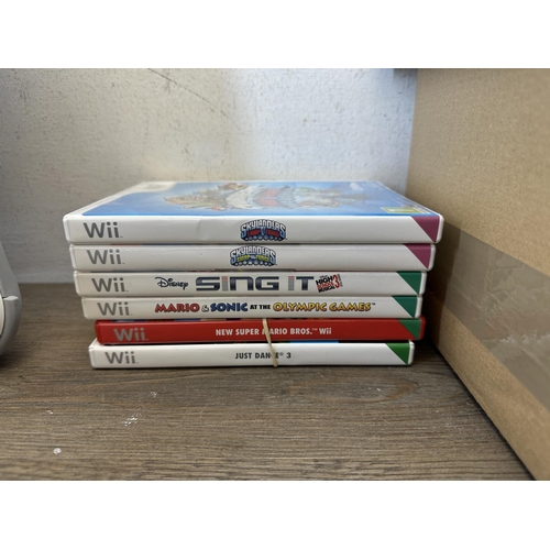 596 - Two Nintendo Wii consoles with games and accessories