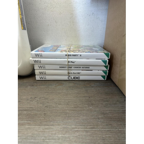 598 - Three Nintendo Wii consoles with games and accessories