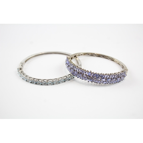 2066 - Two sterling silver gemstone bangles, one tanzanite and one topaz - approx. gross weight 37g