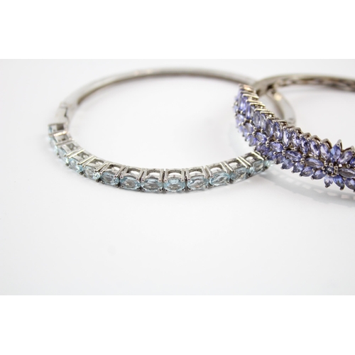 2066 - Two sterling silver gemstone bangles, one tanzanite and one topaz - approx. gross weight 37g