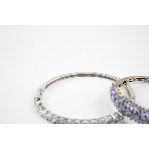 2066 - Two sterling silver gemstone bangles, one tanzanite and one topaz - approx. gross weight 37g