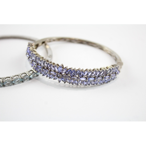 2066 - Two sterling silver gemstone bangles, one tanzanite and one topaz - approx. gross weight 37g