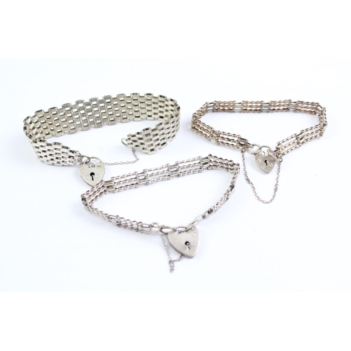 2067 - Three sterling silver gate bracelets with heart padlock clasps - approx. gross weight 43g