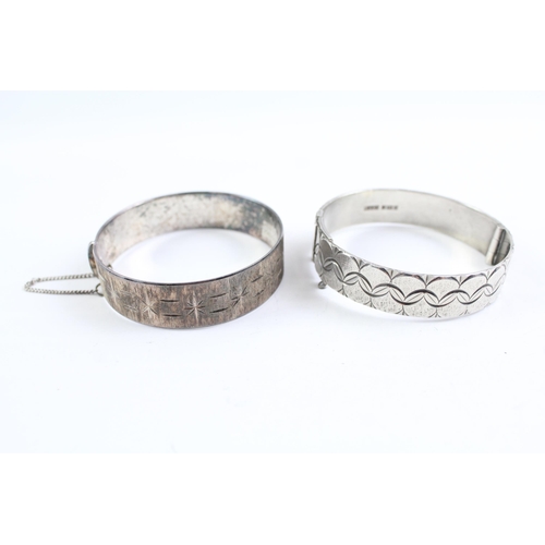 2068 - Two sterling silver bangles, one mid century and one etched - approx. gross weight 71g