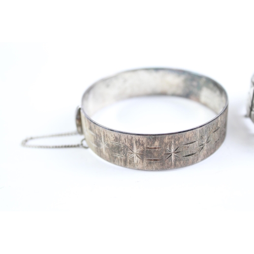 2068 - Two sterling silver bangles, one mid century and one etched - approx. gross weight 71g