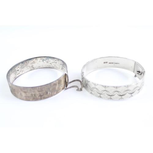 2068 - Two sterling silver bangles, one mid century and one etched - approx. gross weight 71g