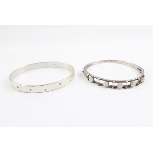 2091 - Two sterling silver gemstone bangles, one diamond and one opal - approx. gross weight 44g