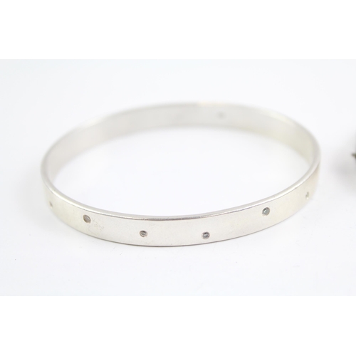 2091 - Two sterling silver gemstone bangles, one diamond and one opal - approx. gross weight 44g