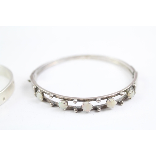 2091 - Two sterling silver gemstone bangles, one diamond and one opal - approx. gross weight 44g