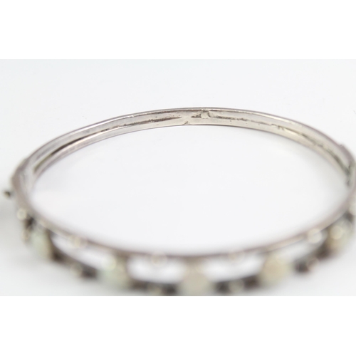 2091 - Two sterling silver gemstone bangles, one diamond and one opal - approx. gross weight 44g