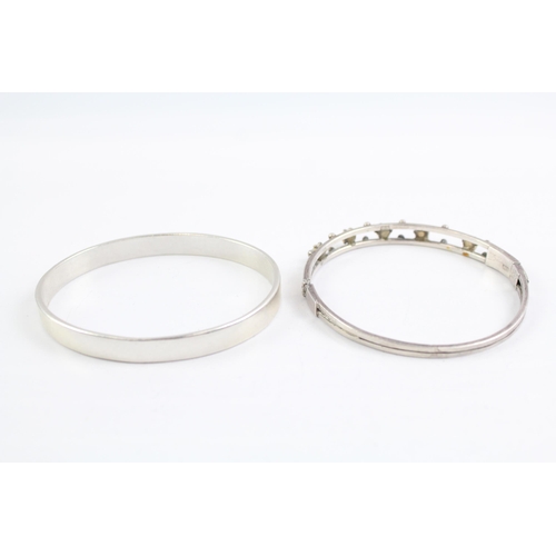 2091 - Two sterling silver gemstone bangles, one diamond and one opal - approx. gross weight 44g