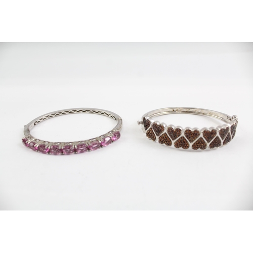 2099 - Two sterling silver gemstone bangles, one diamond and one topaz - approx. gross weight 46g