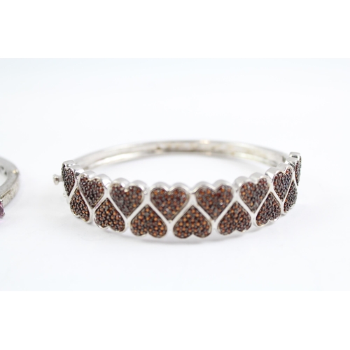 2099 - Two sterling silver gemstone bangles, one diamond and one topaz - approx. gross weight 46g