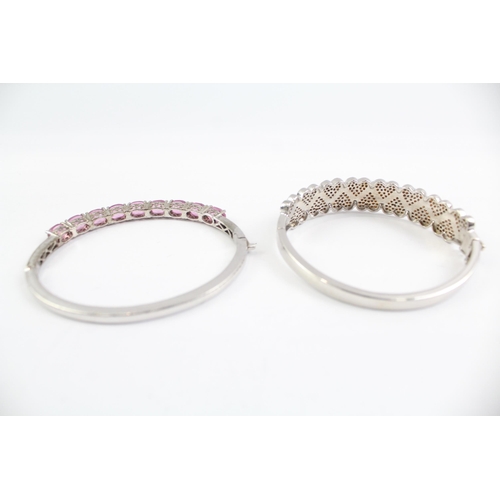 2099 - Two sterling silver gemstone bangles, one diamond and one topaz - approx. gross weight 46g